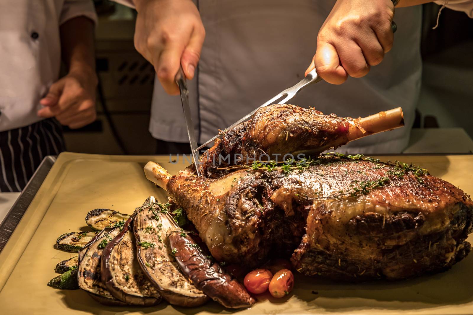 Carving of Roasted lamb meat