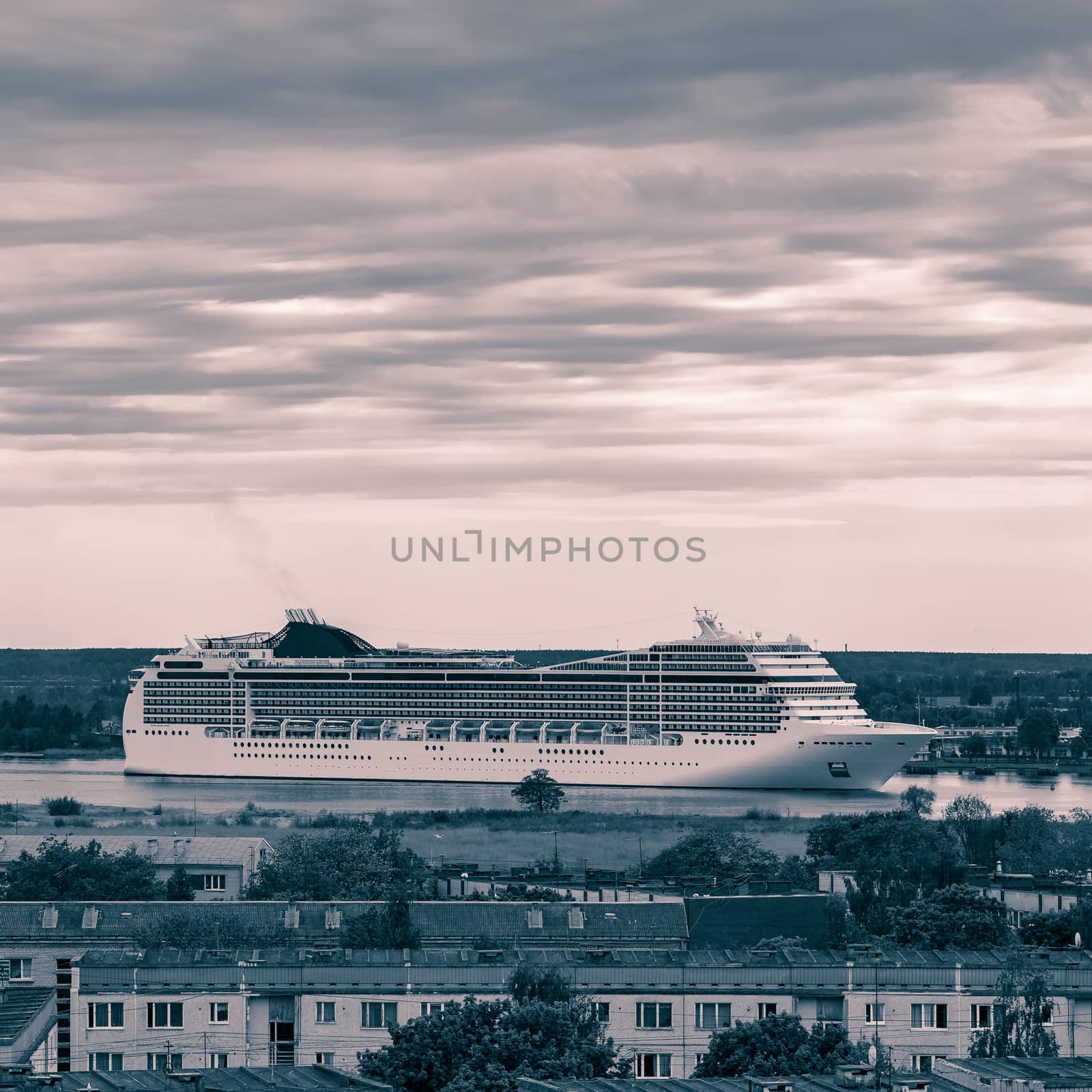 Large cruise liner sailing past the cargo port. Monochrome