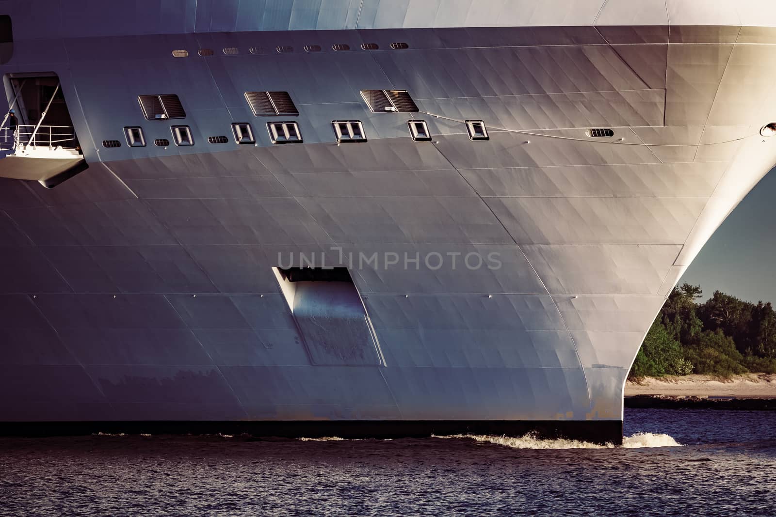 White giant brand new passenger ship moving in clear summer day