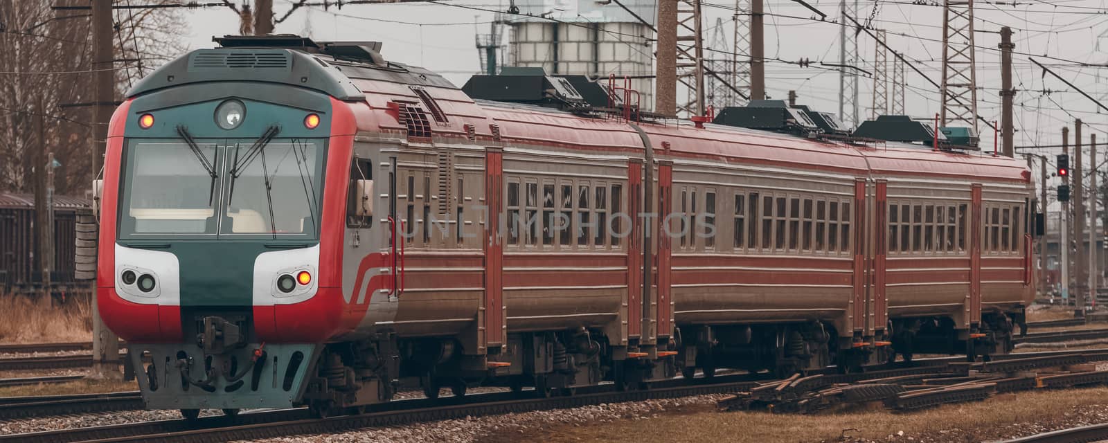 Red diesel passenger train driving at the old terminal