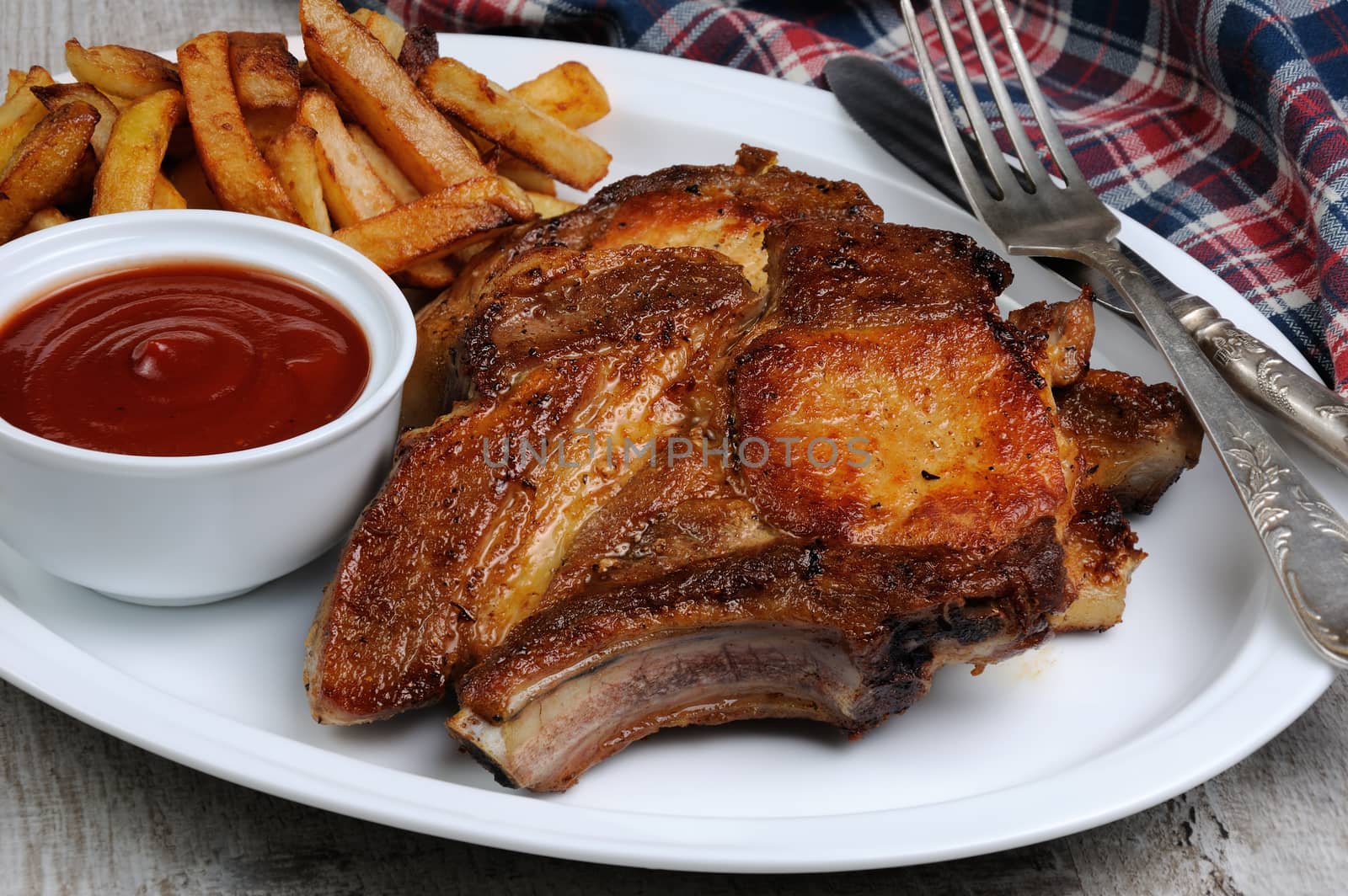 Fried pork loin steak with French fries and tomato sauce