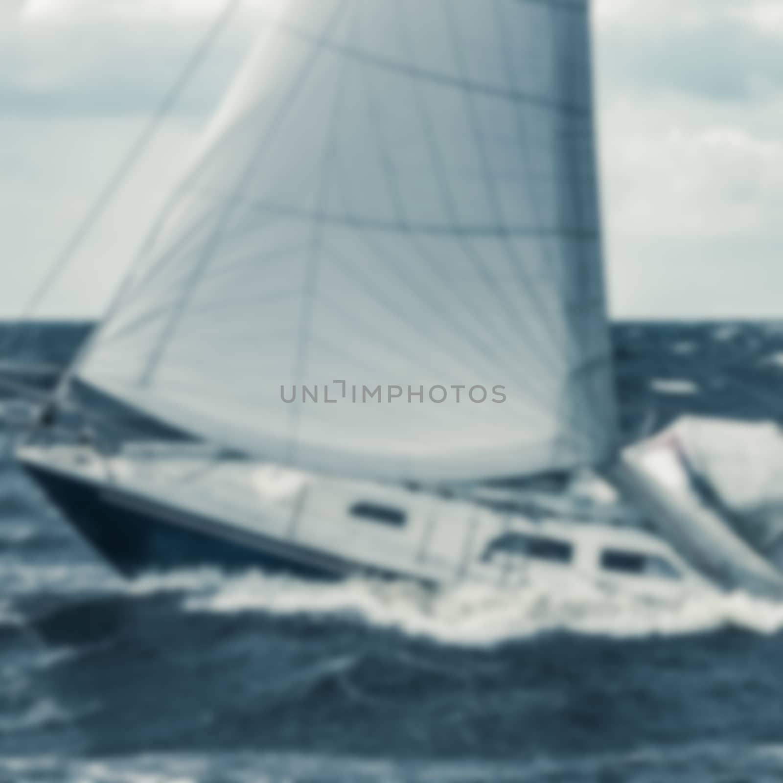 Blue sailboat - soft lens bokeh image. Defocused background