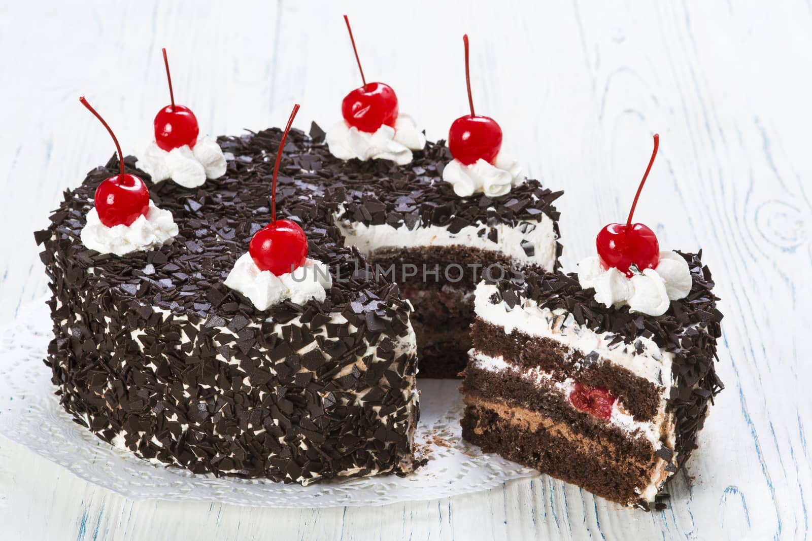 Chocolate cake with cherry on light background