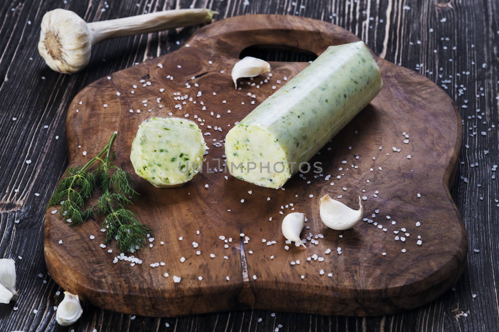 Lard with salt, garlic and herbs, wooden background