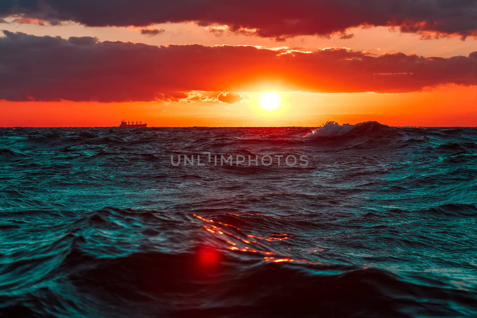 Waves in the ocean against hot and romantic sunset