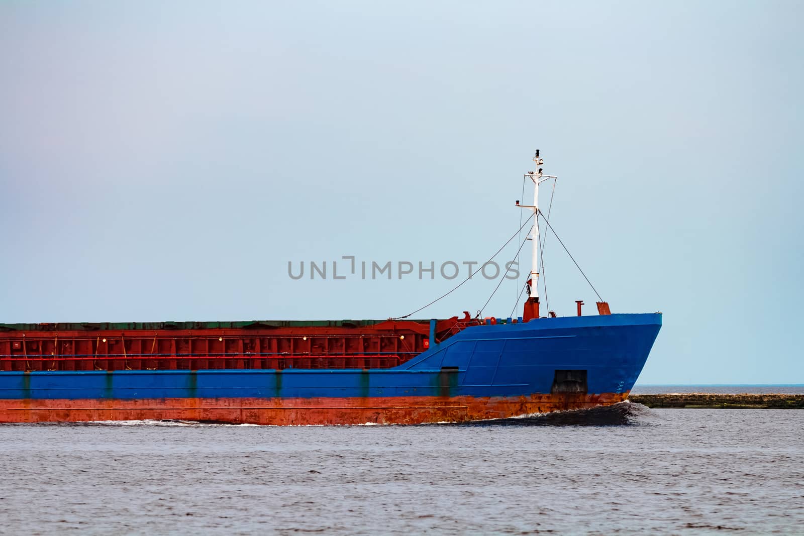 Blue cargo ship underway by sengnsp
