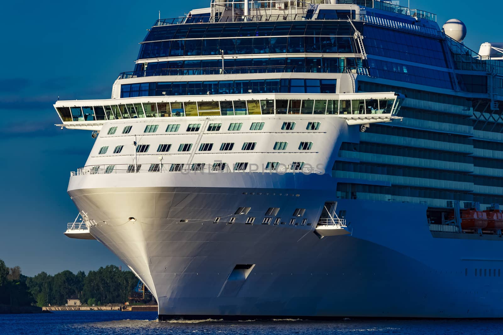 White giant brand new passenger ship moving in clear summer day