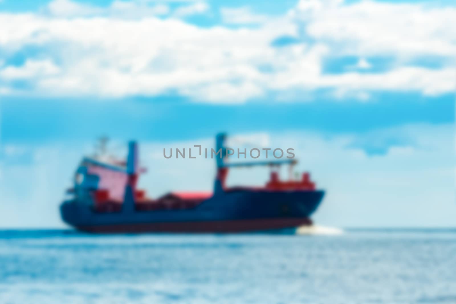 Blue cargo ship - soft lens bokeh image. Defocused background