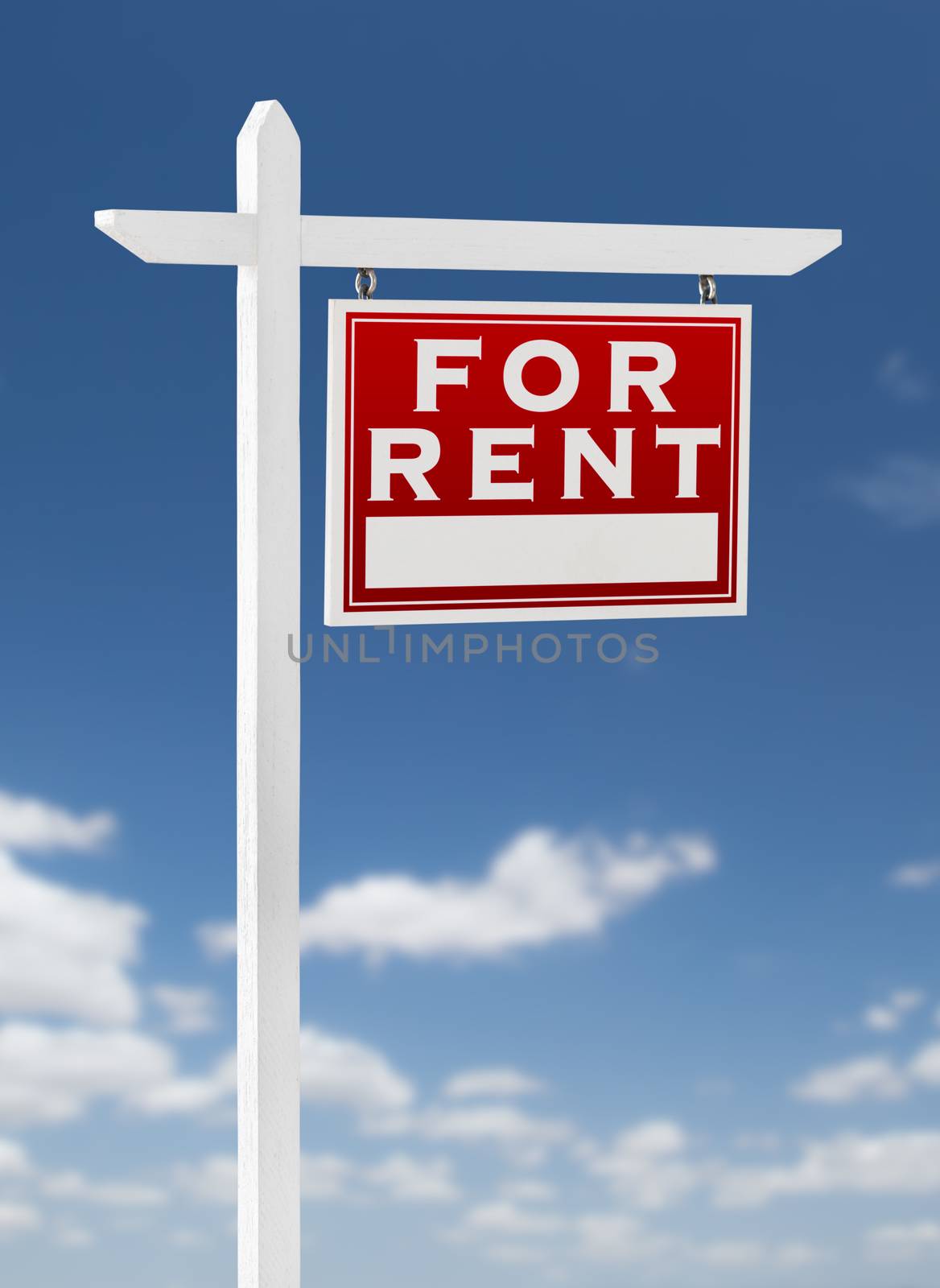 Right Facing For Rent Real Estate Sign on a Blue Sky with Clouds.