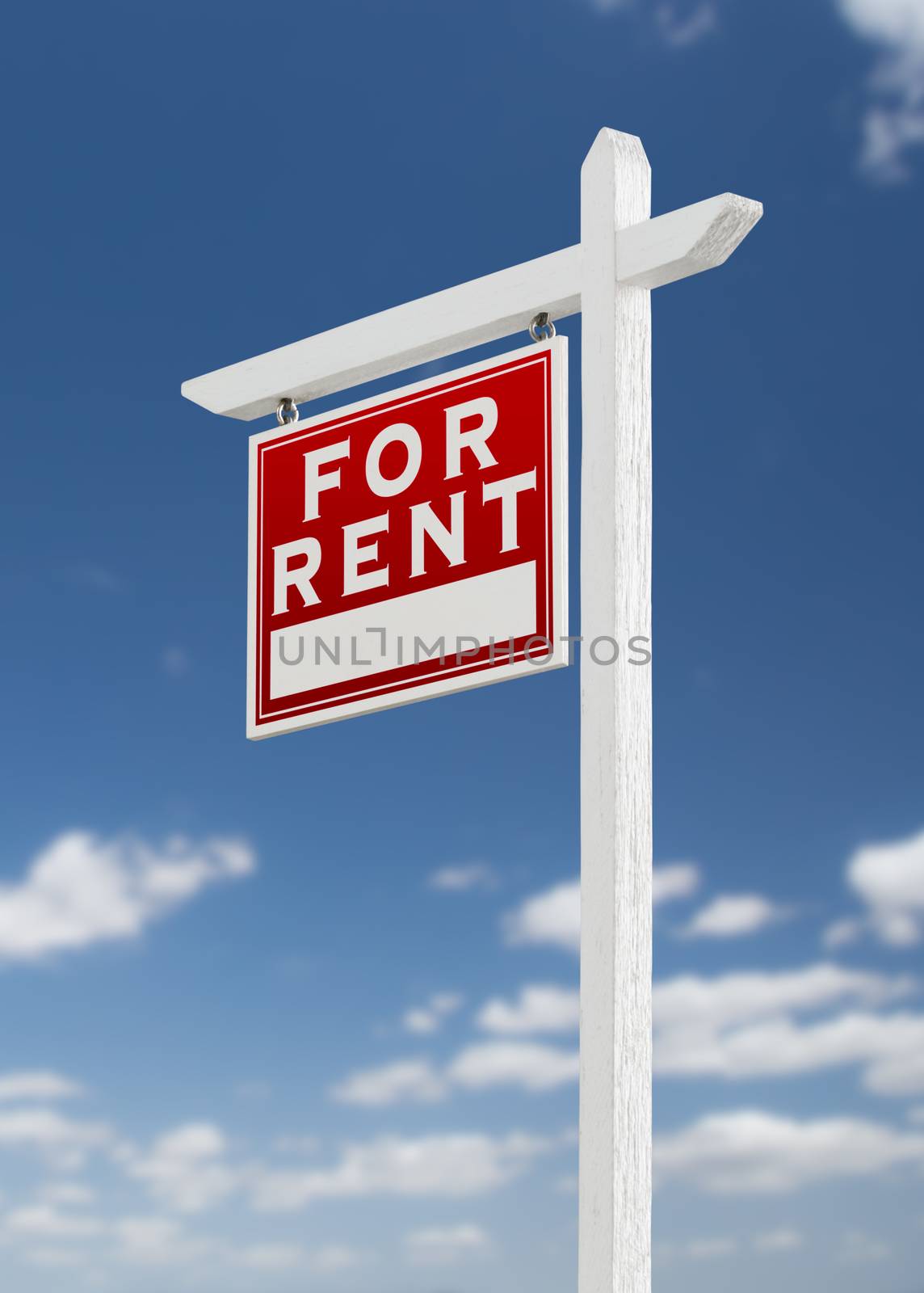 Left Facing For Rent Real Estate Sign on a Blue Sky with Clouds.