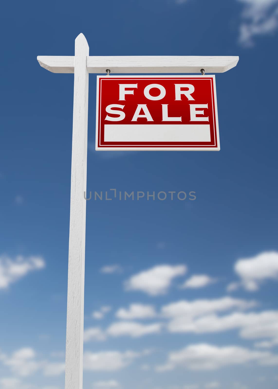 Right Facing For Sale Real Estate Sign on a Blue Sky with Clouds.