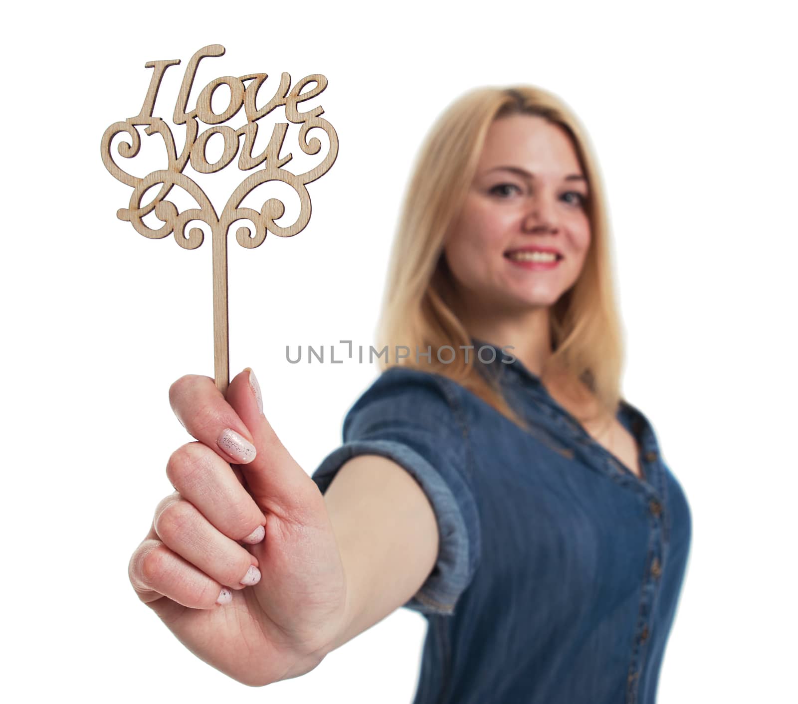 Young woman holding a sign "I love you" in hand. Valentine day concept.