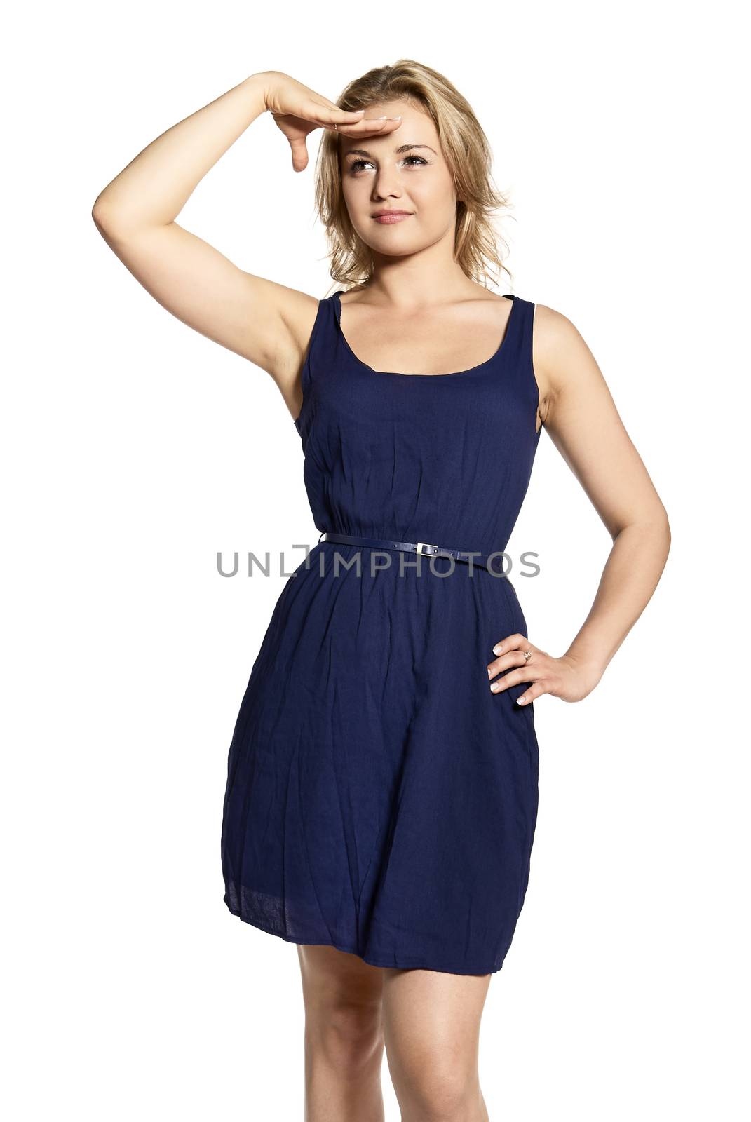 Studio shot of young blonde woman wearing a blue dress. She looks out for a bargain, love or work. Advertising concept.

