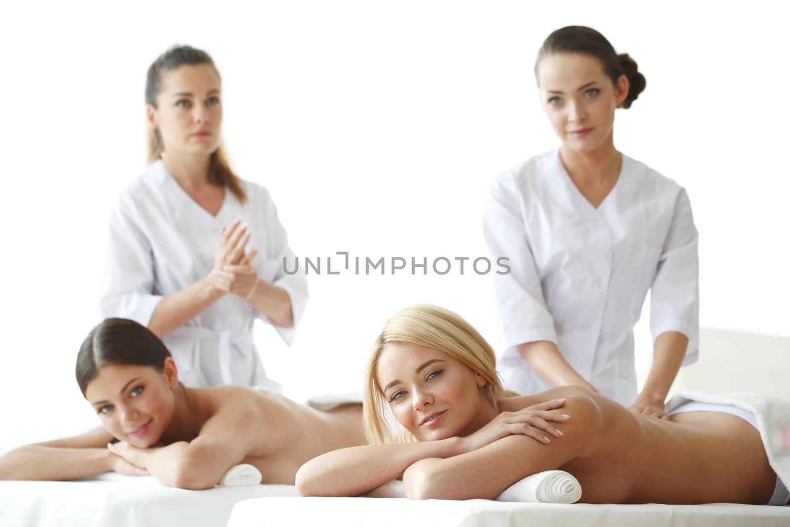Two beautiful women getting massage in spa