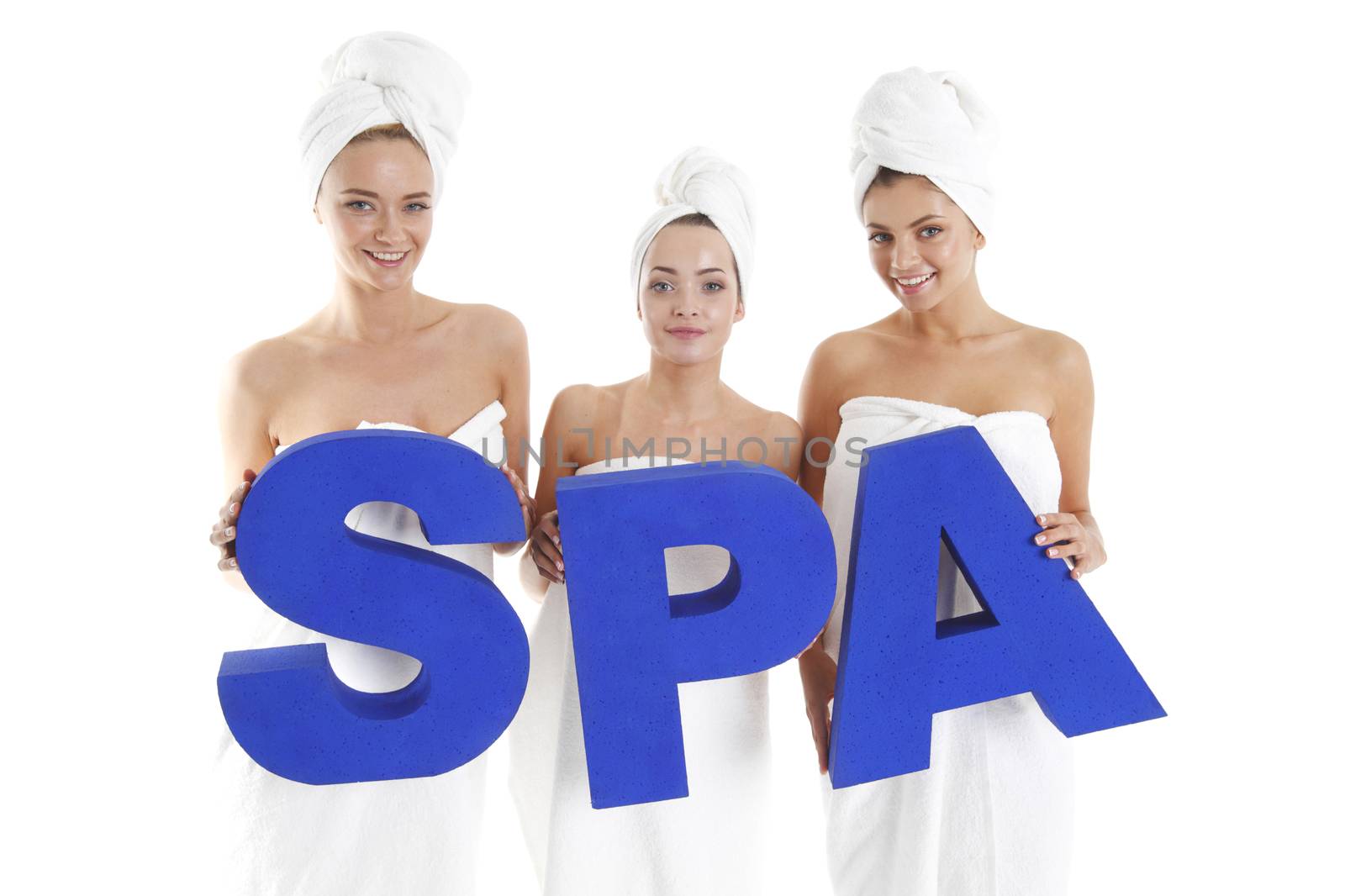Women wrapped in towels holdin SPA letters isolated on white background