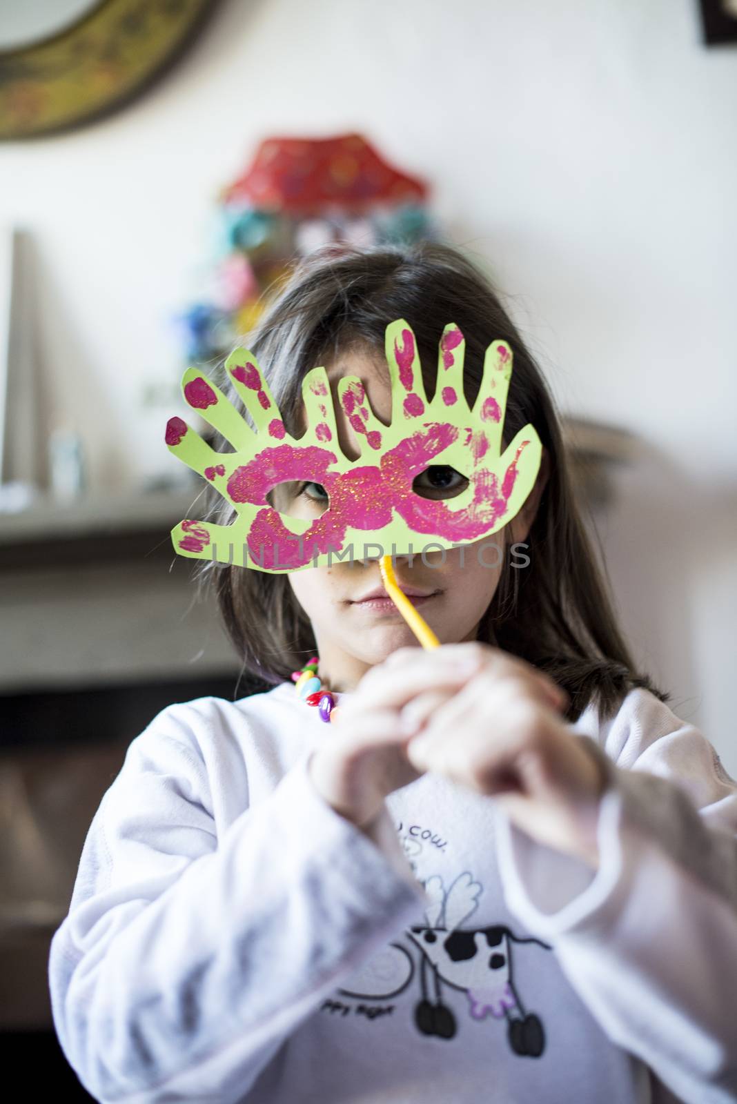 portrait of a 6 year old boy with a carnival mask made by himself at home