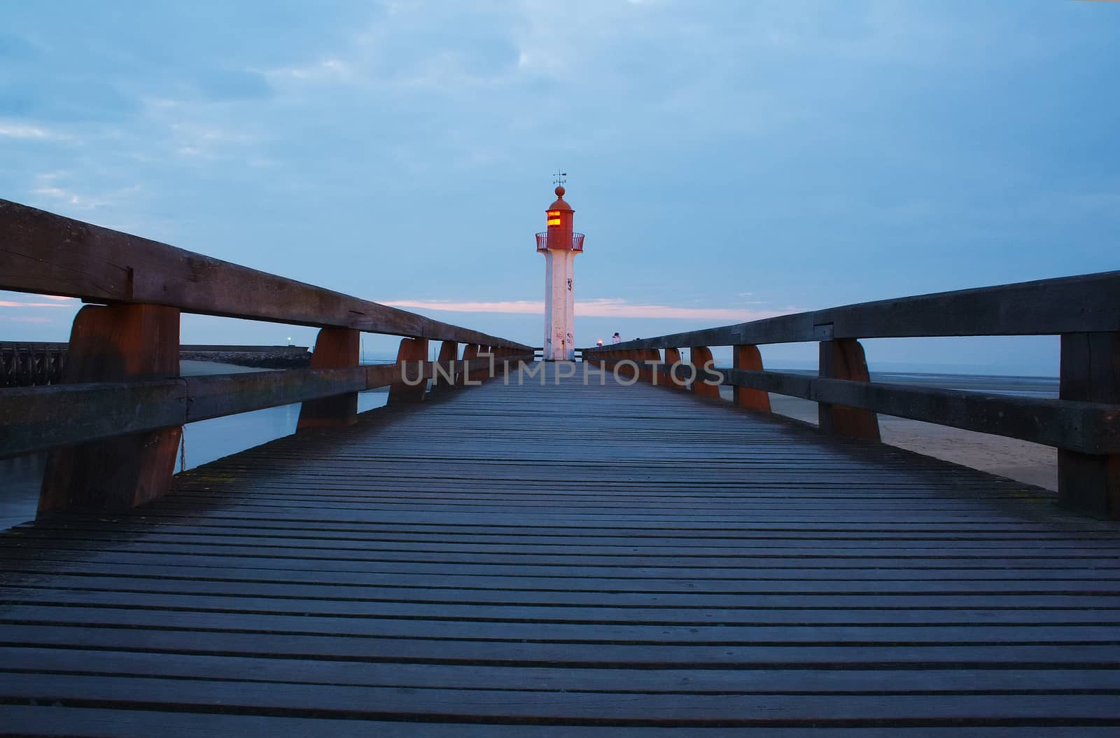 Walkway and lighthouse at sunset by totony