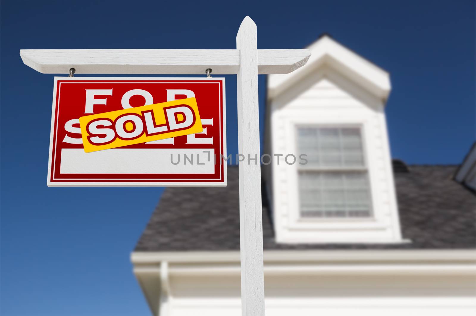 Left Facing Sold For Sale Real Estate Sign In Front of House and Deep Blue Sky. by Feverpitched