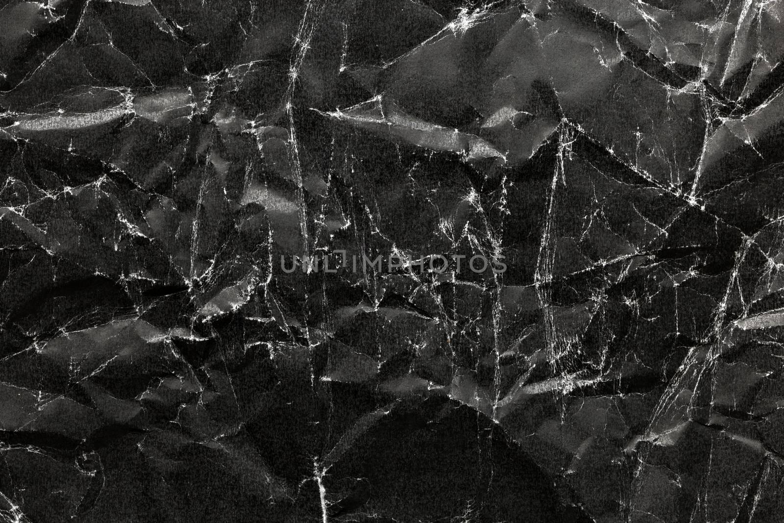 Black Crumpled Paper Background. Black crumpled paper texture.