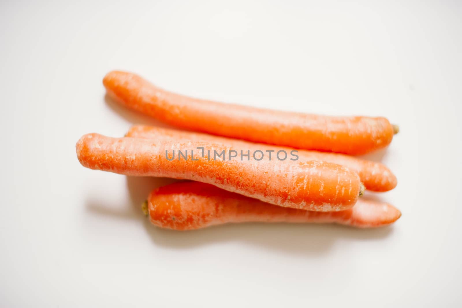 still-life photograph of carrots on white background