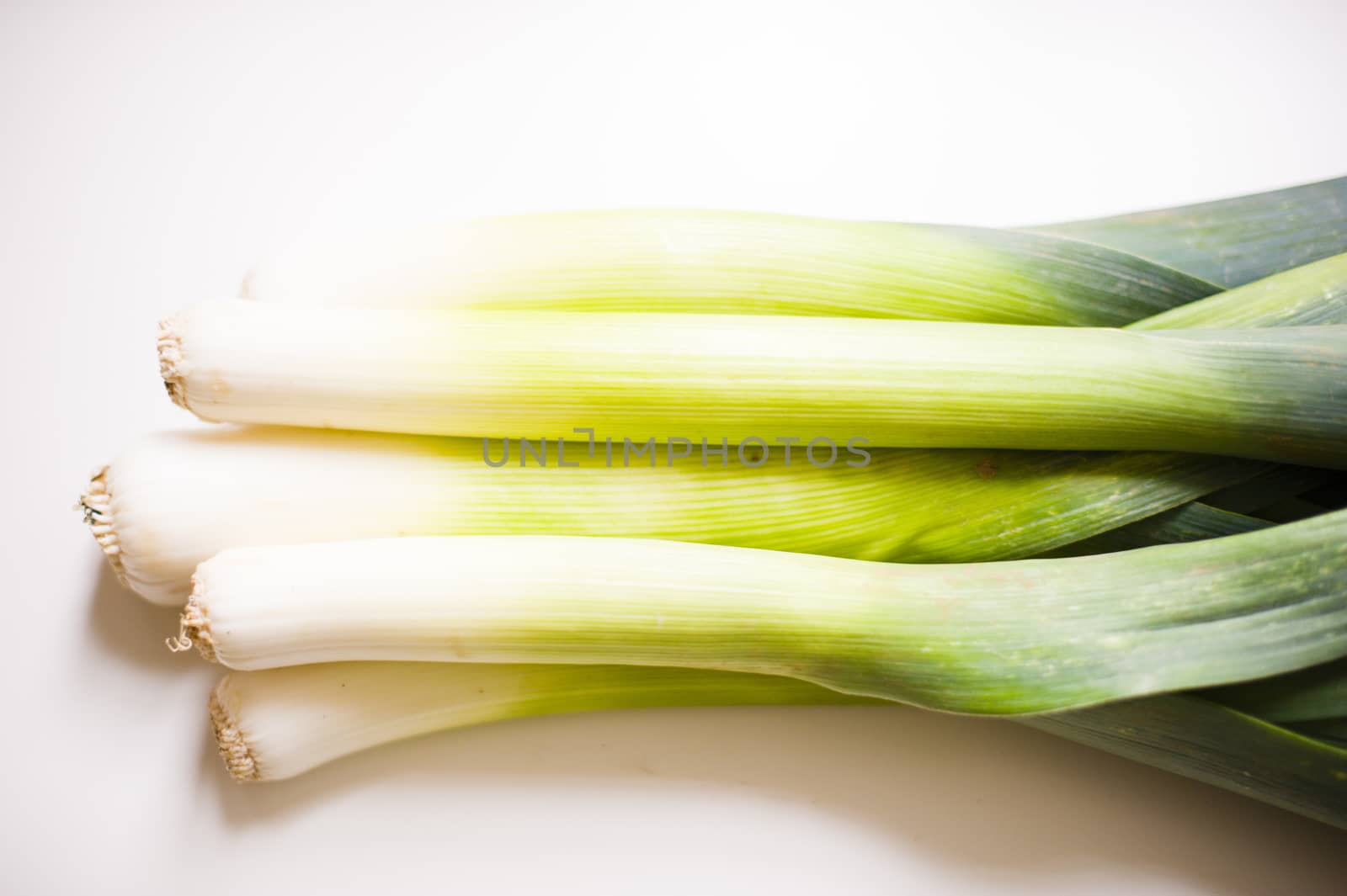 still life of vegetable leeks on white background