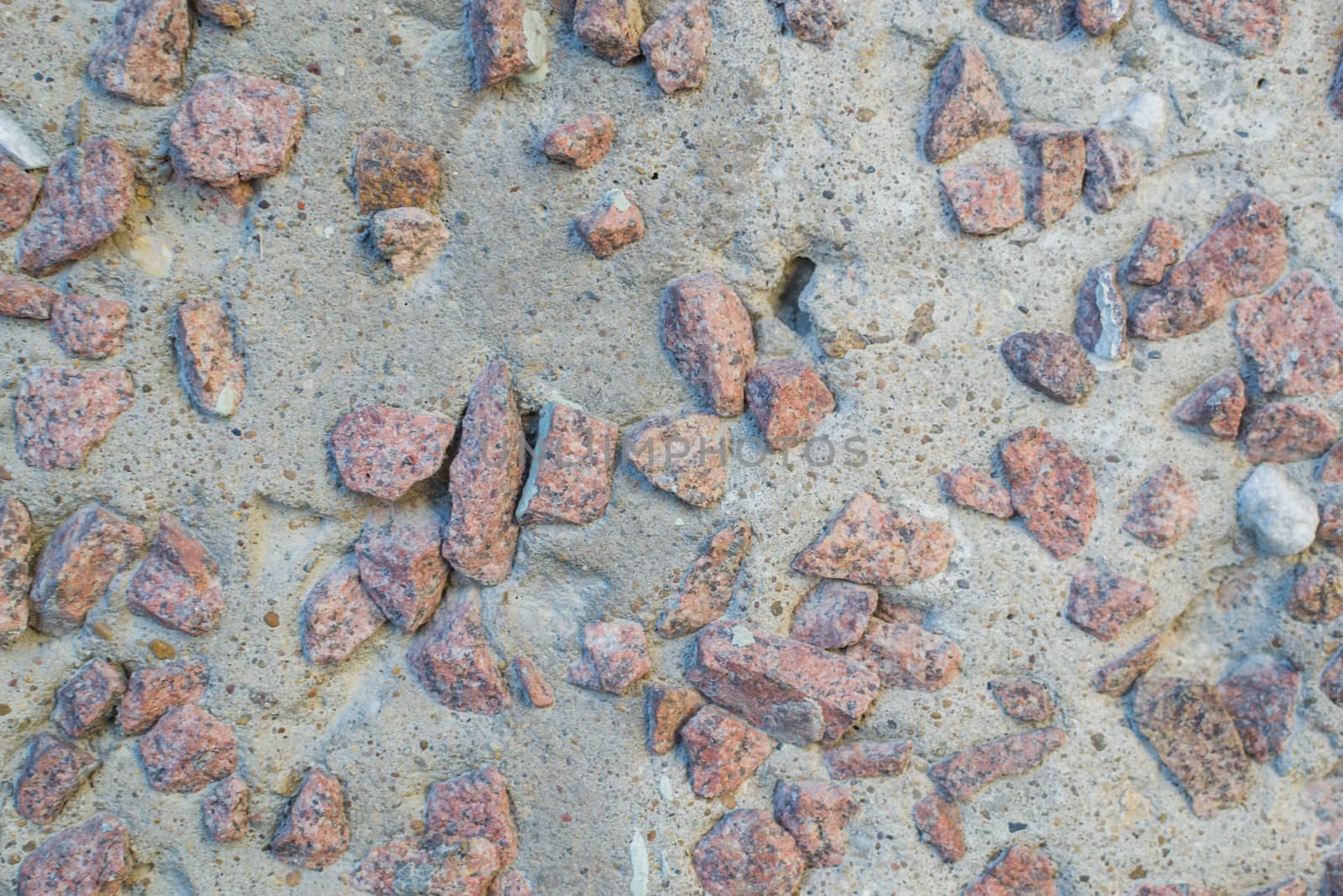 the texture of the stone in plaster red stones on a white background