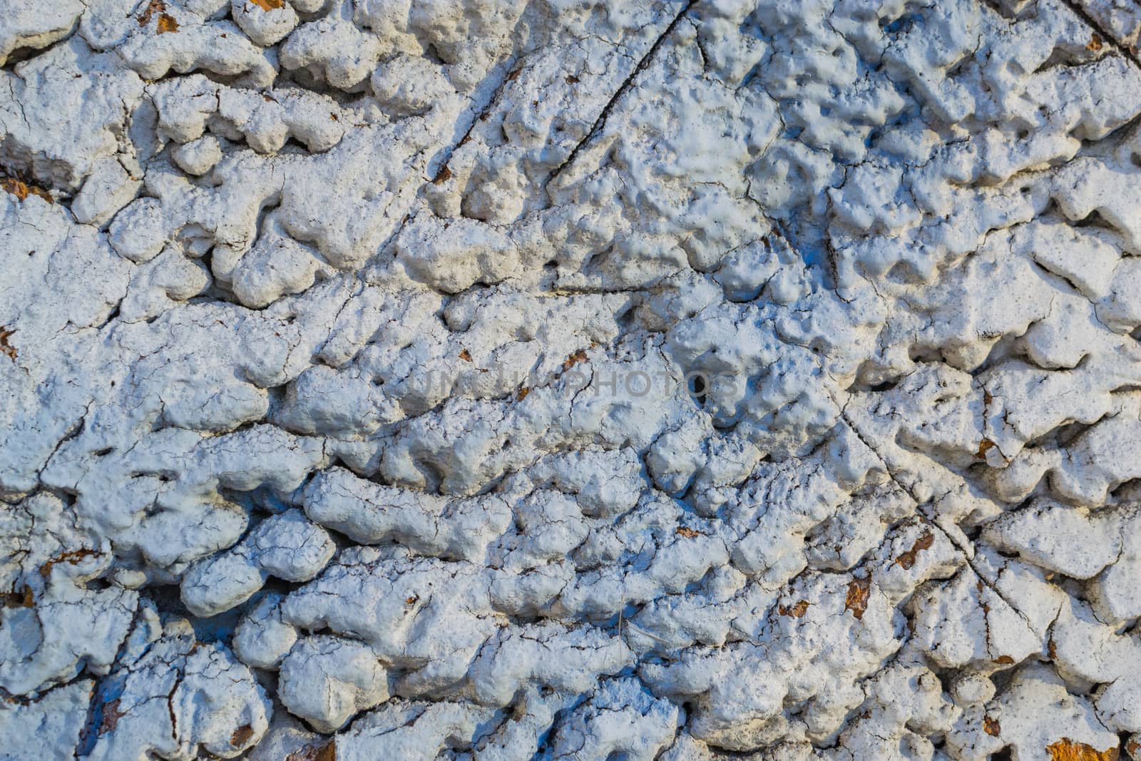 the texture of the stone in plaster red stones on a white background