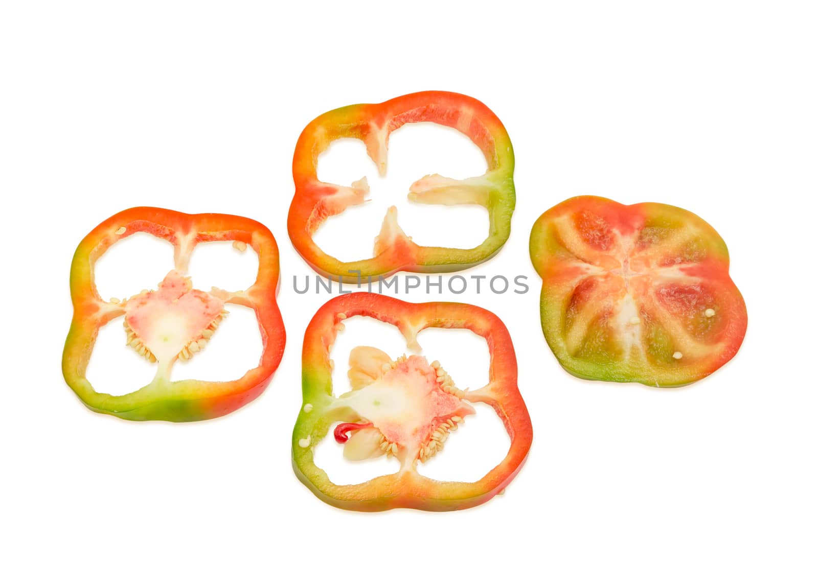 Orange-green fresh bell pepper sliced by rings on a light background
