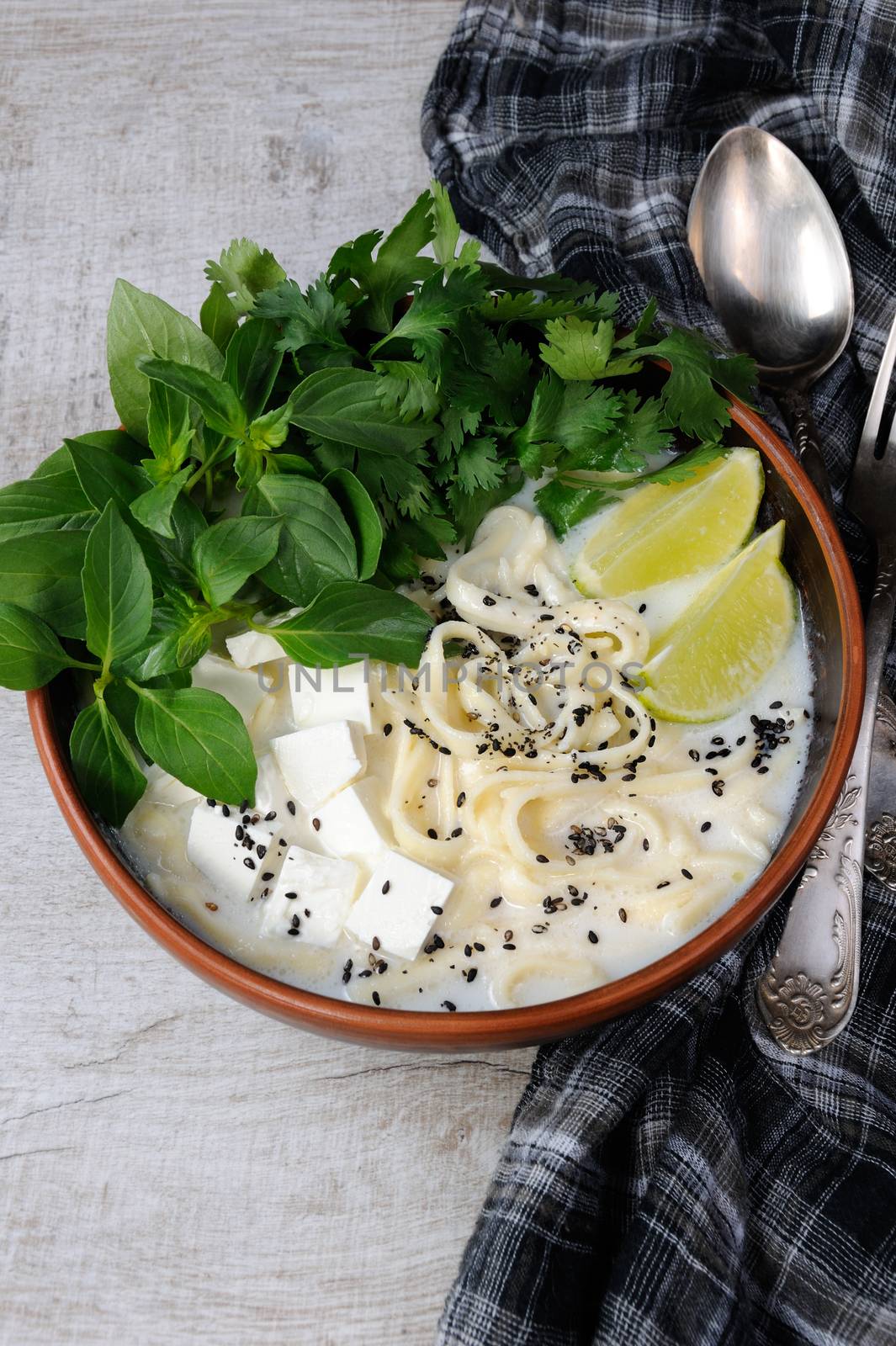 Rice soup with noodles and tofu flavored with lemon grass (basil), cilantro, sesame.
