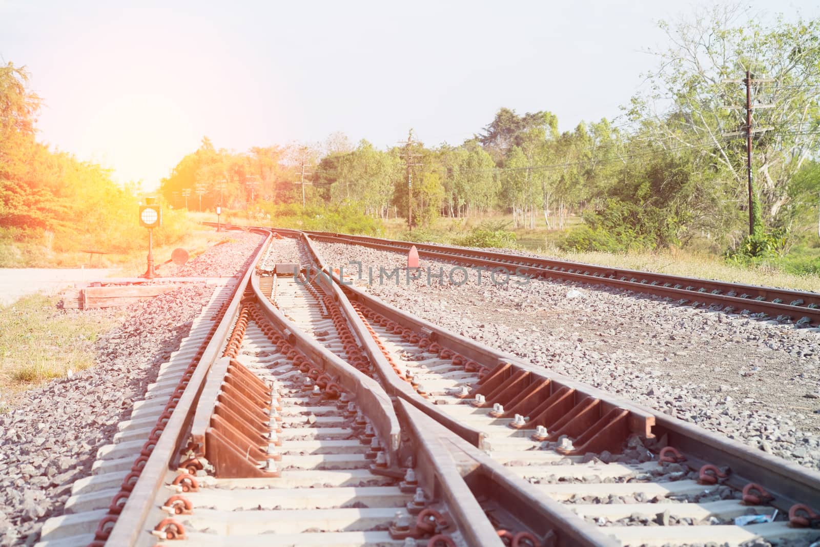 Railroad tracks in beautiful, Orange sunset in low clouds over railroad.