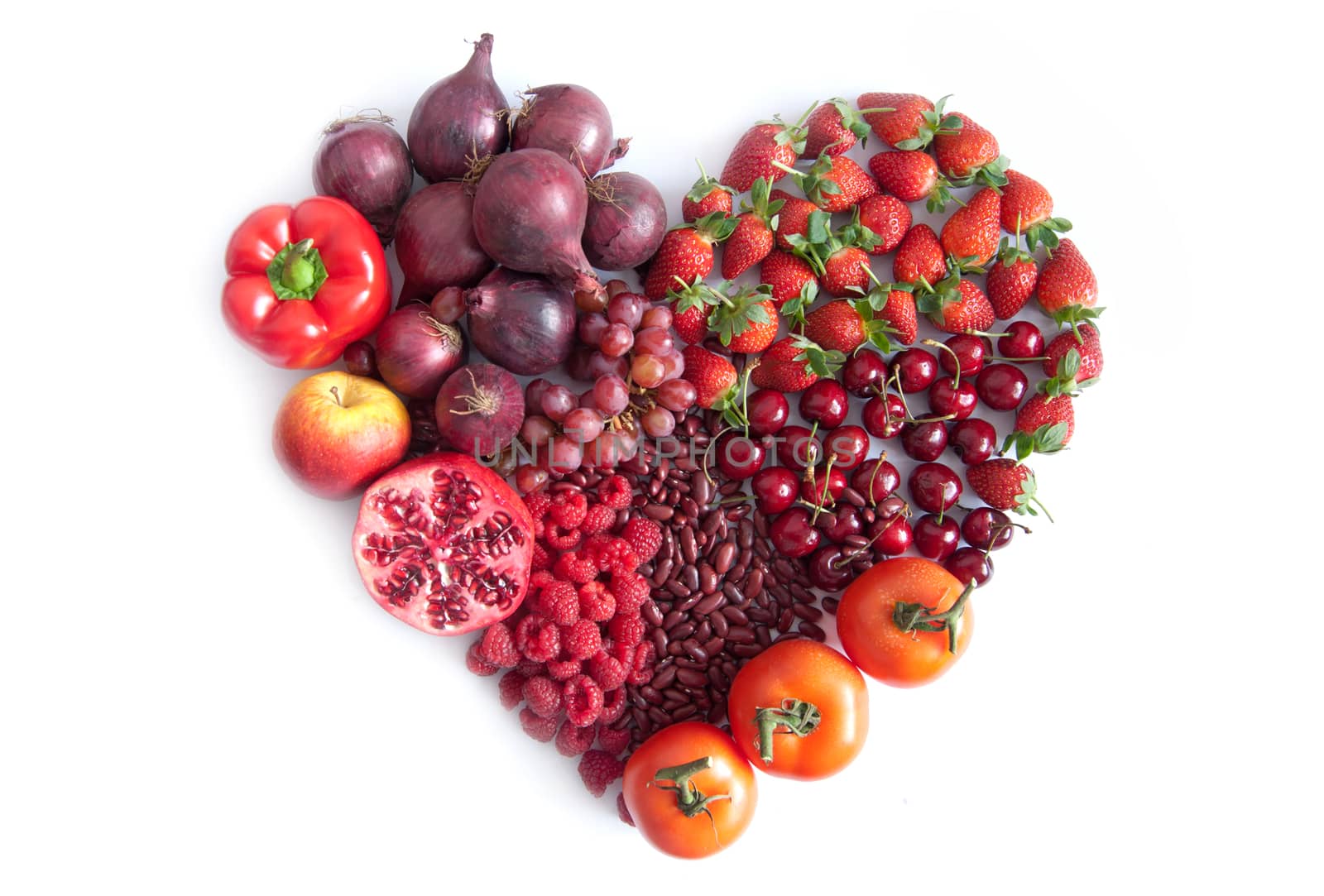Red fruits, vegetables and pulses in the shape of a heart