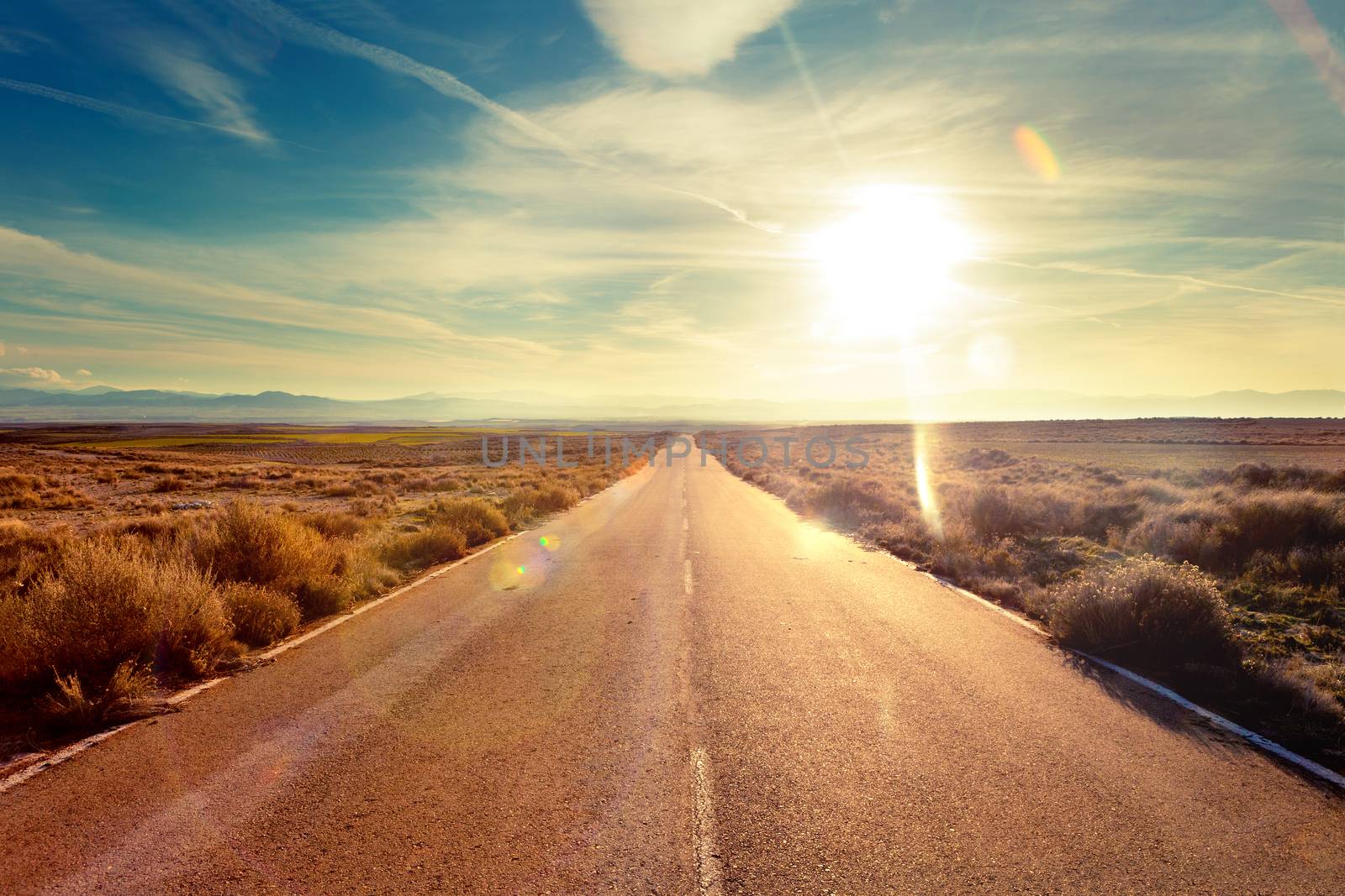 Road through landscape. Road and car travel scenic and sunset.