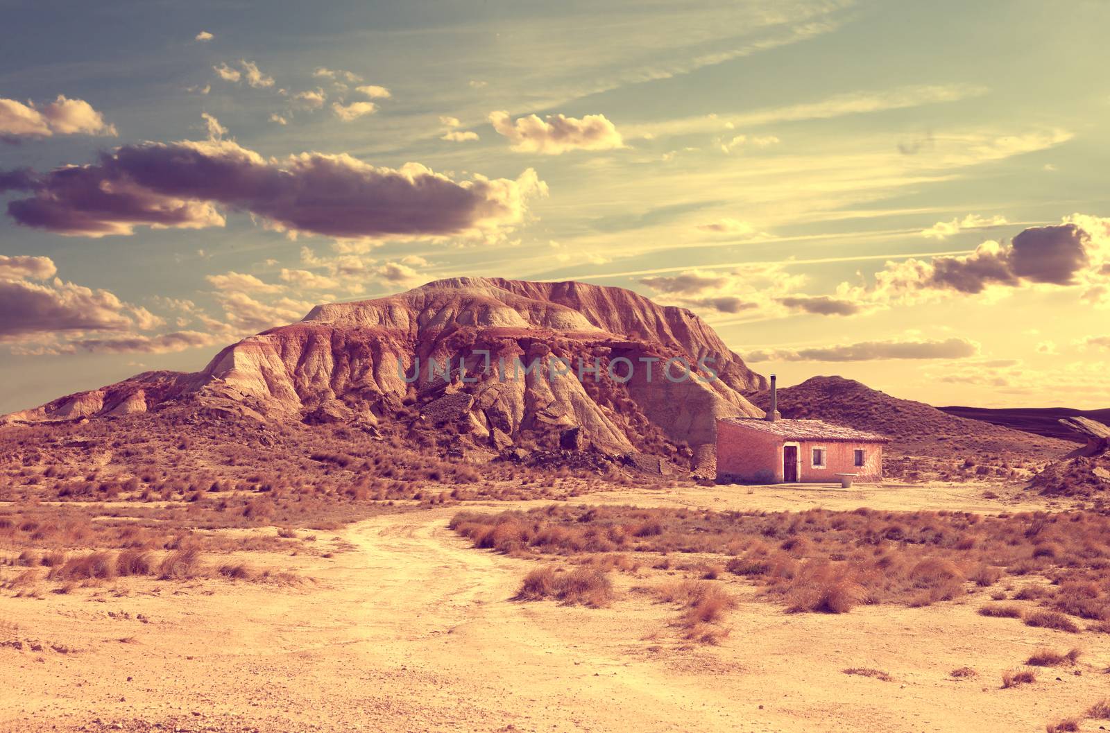 Desert lanscape.House and road in sunset landscape