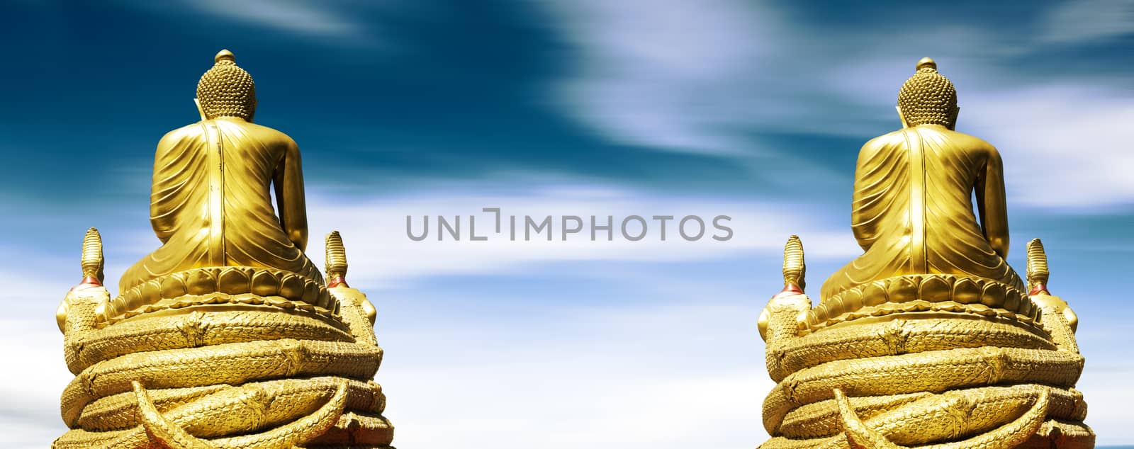 Golden Buddha statue over blue sky background.Asian and buddhist culture