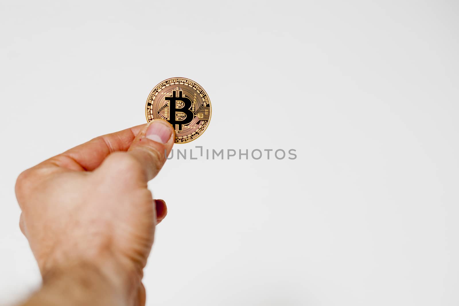 bitcoin electronic coin holding in the hand white background