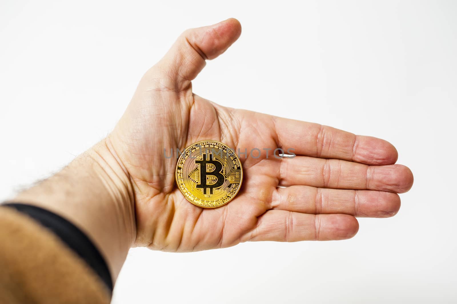 bitcoin electronic coin holding in the hand white background