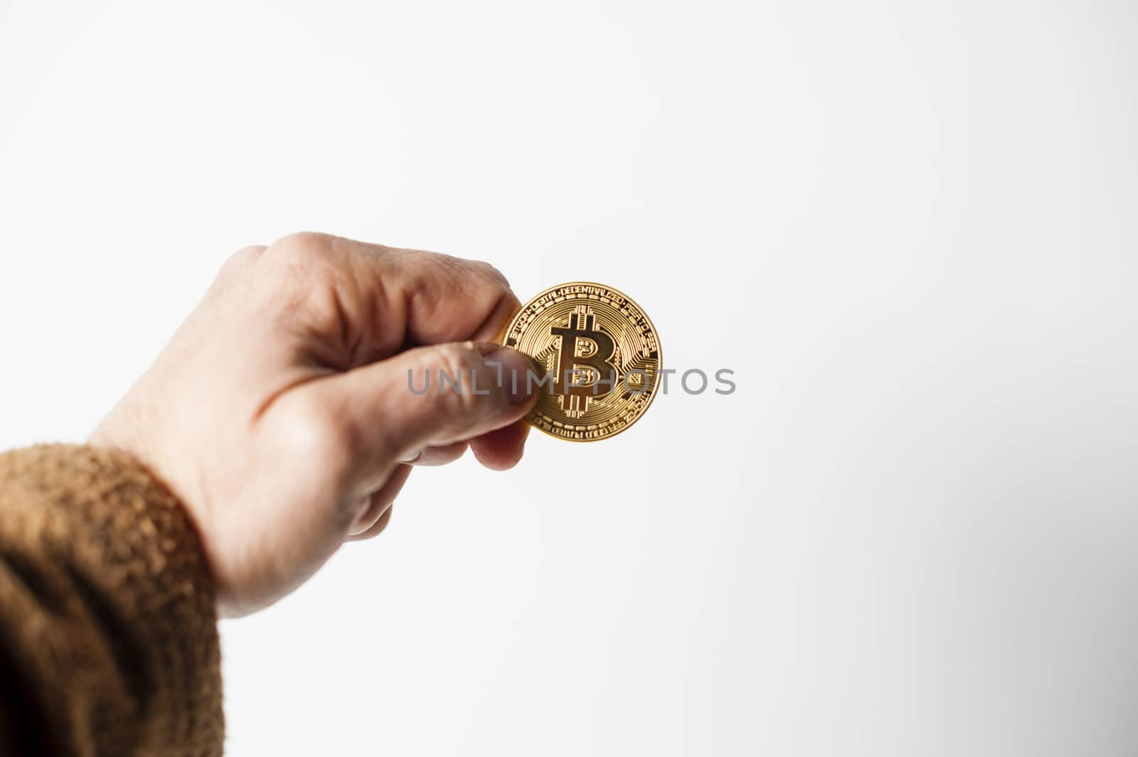 bitcoin electronic coin holding in the hand white background