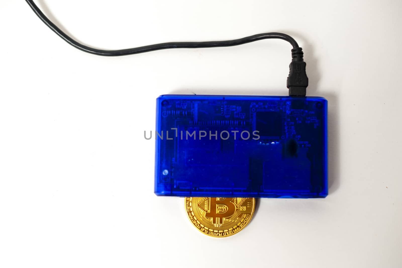 bitcoin electronic coin inside a digital card reader, white background