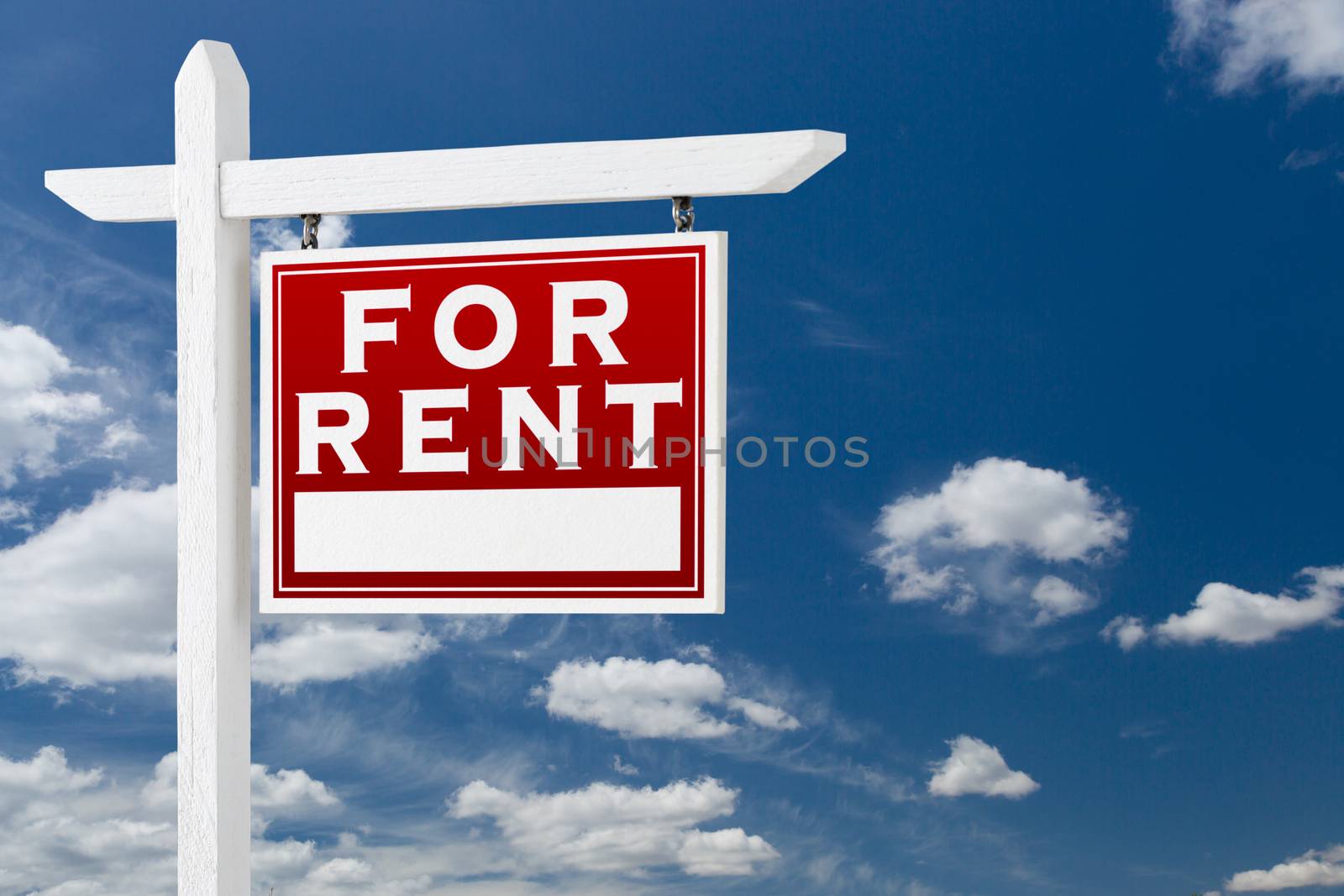 Right Facing For Rent Real Estate Sign Over Blue Sky and Clouds With Room For Your Text.