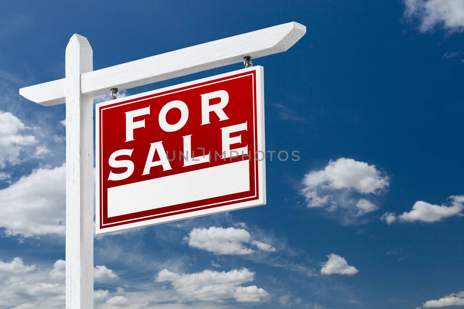 Right Facing For Sale Real Estate Sign Over Blue Sky and Clouds With Room For Your Text.