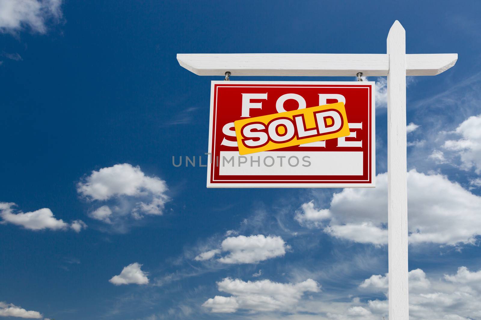 Left Facing Sold For Sale Real Estate Sign Over Blue Sky and Clo by Feverpitched