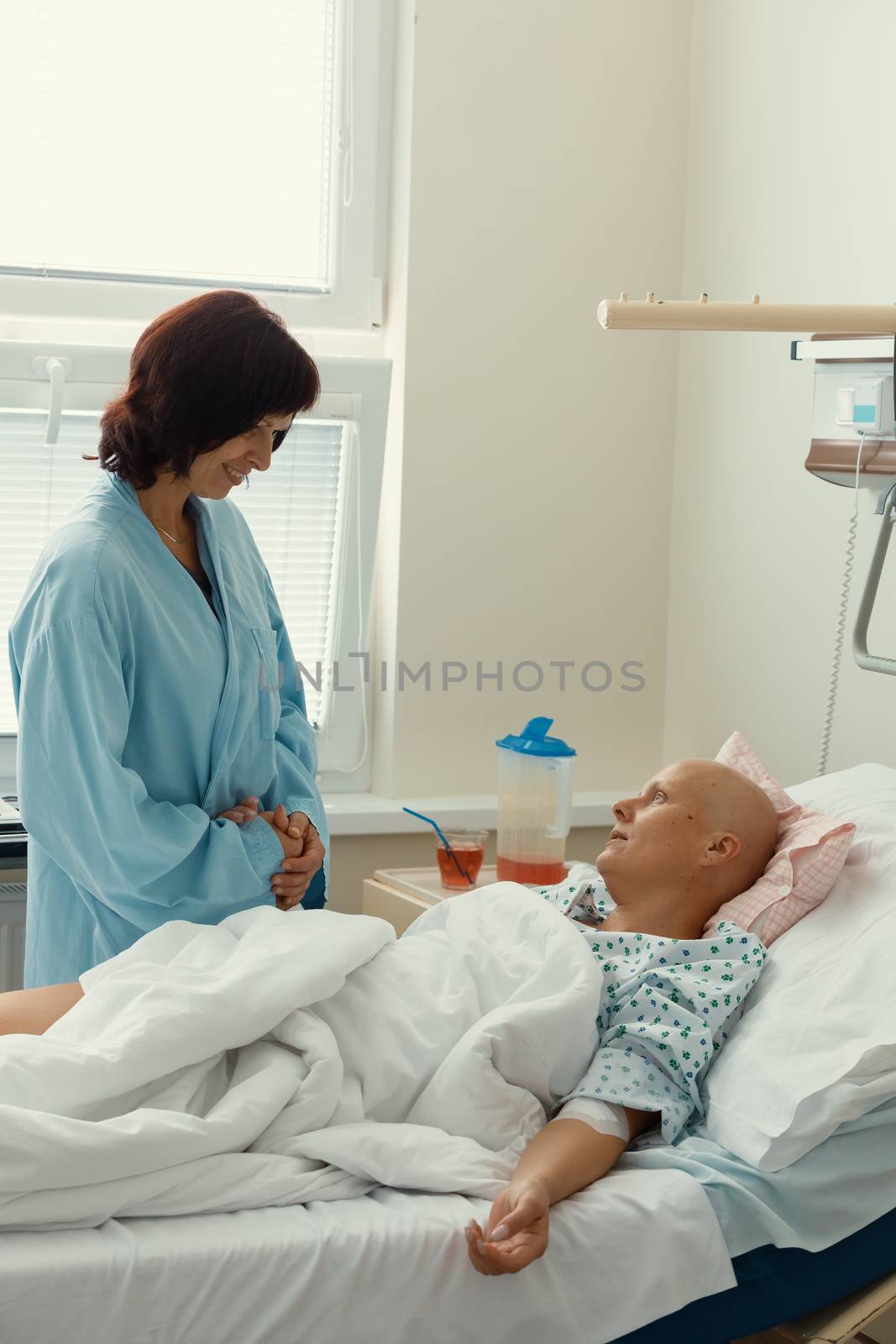 woman patient with cancer in hospital with friend by artush