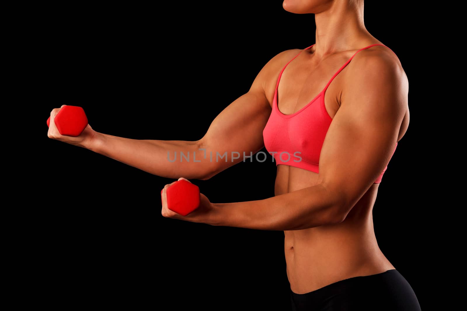 Sporty young woman with dumbbells isolated on black background, closeup shot