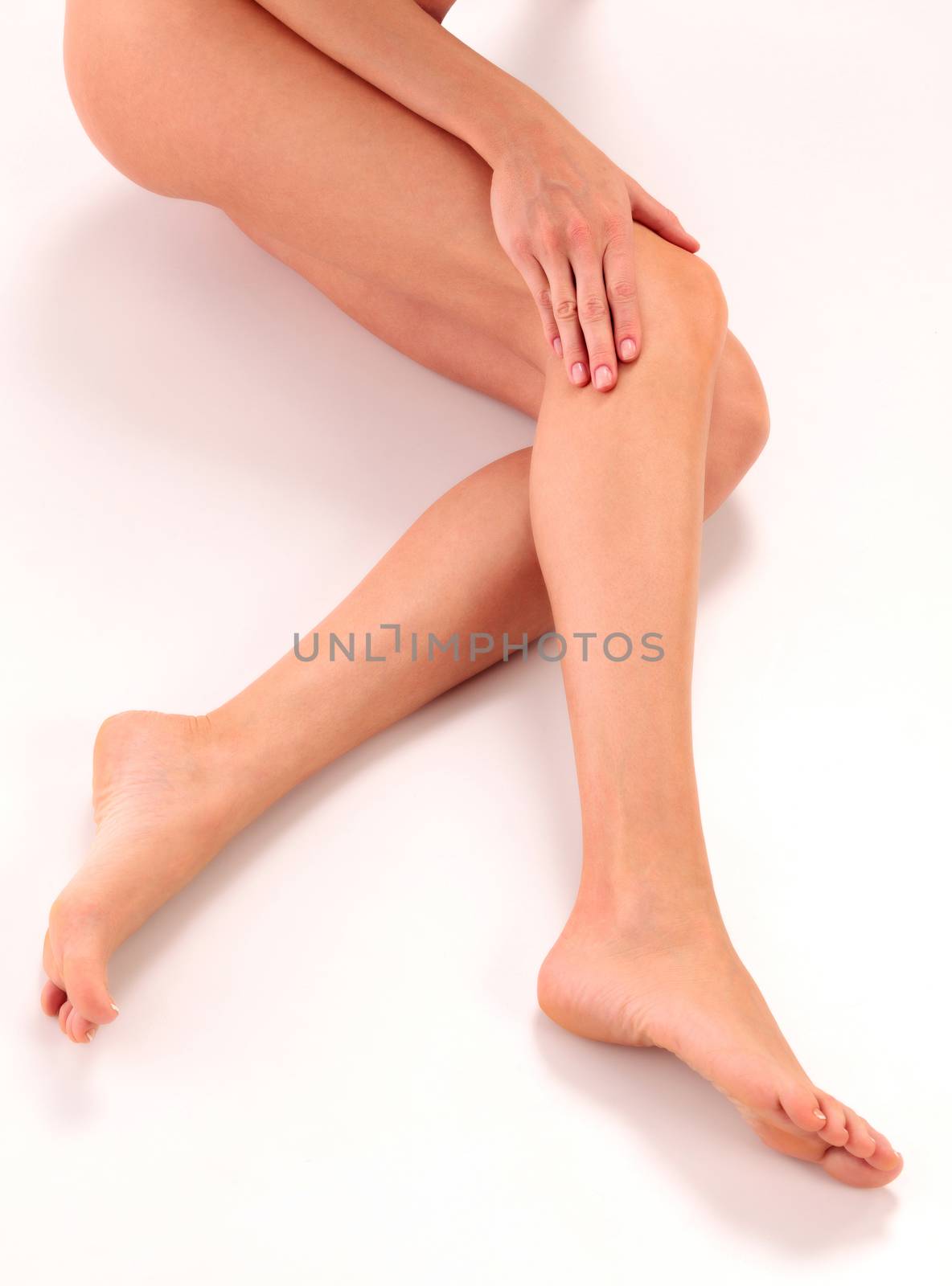 Closeup shot of healthy naked woman legs with soft clear skin on by Nobilior