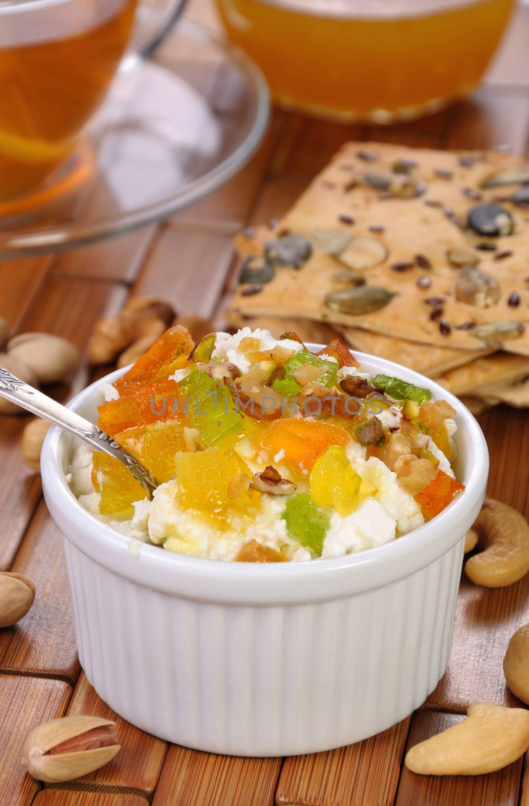 portion of cottage cheese with jam and marmalade slices, nuts, pistachios