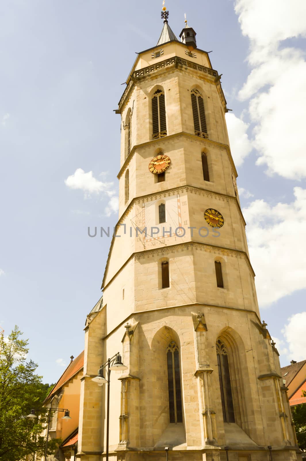Superb tower of an old stone church in a German village