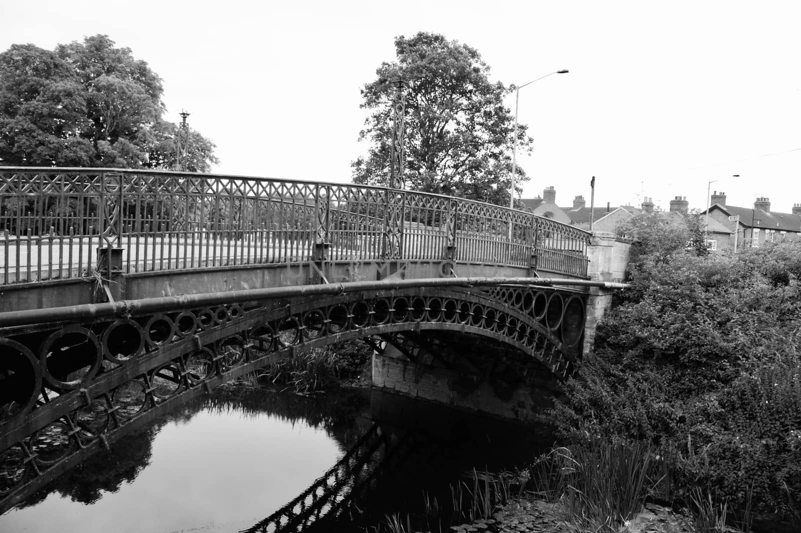 Old bridge with circles in Town Centre in Newport Pagnell. River and tree.
