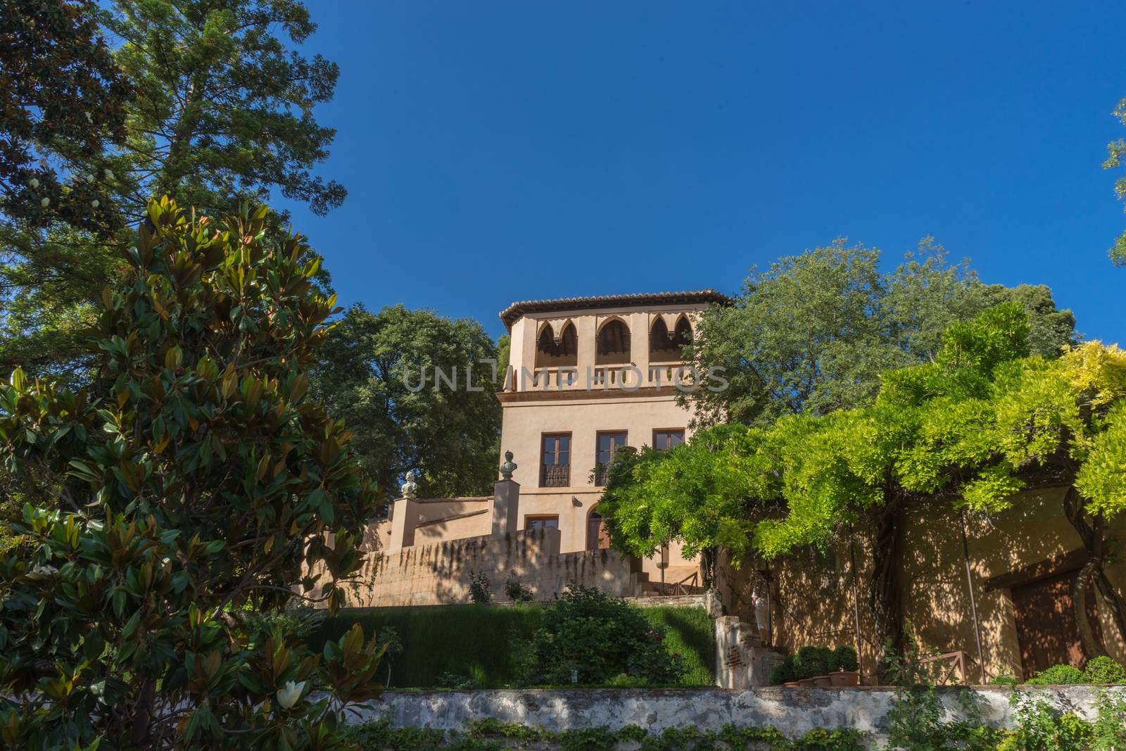 View of the bell tower of the Alhambra  from the Generalife gardens in Granada, Spain, Europe on a bright summer day