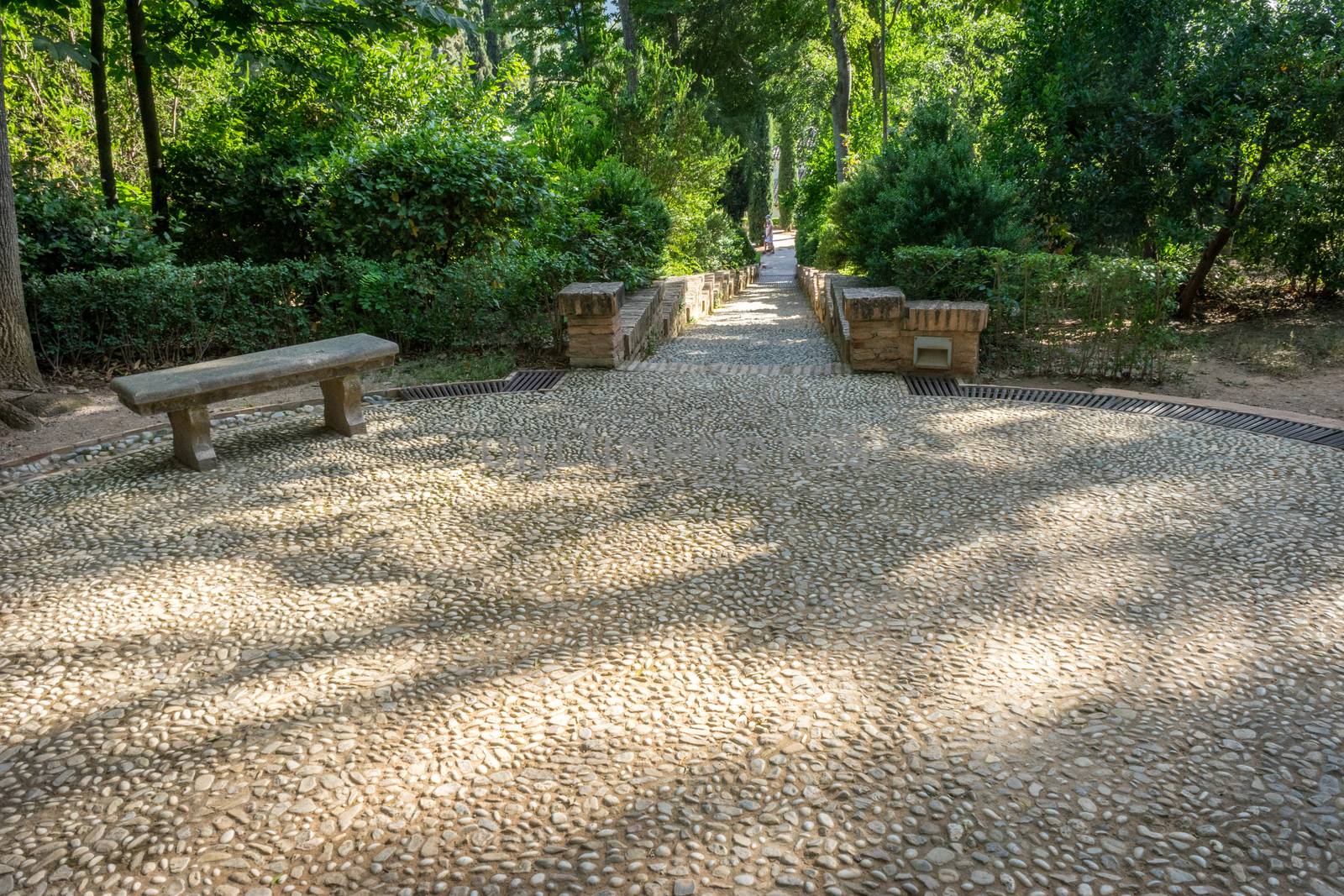 Circular patterns on a stone walking path at the Alhambra palace in Granada, Spain, Europe on a bright summer day