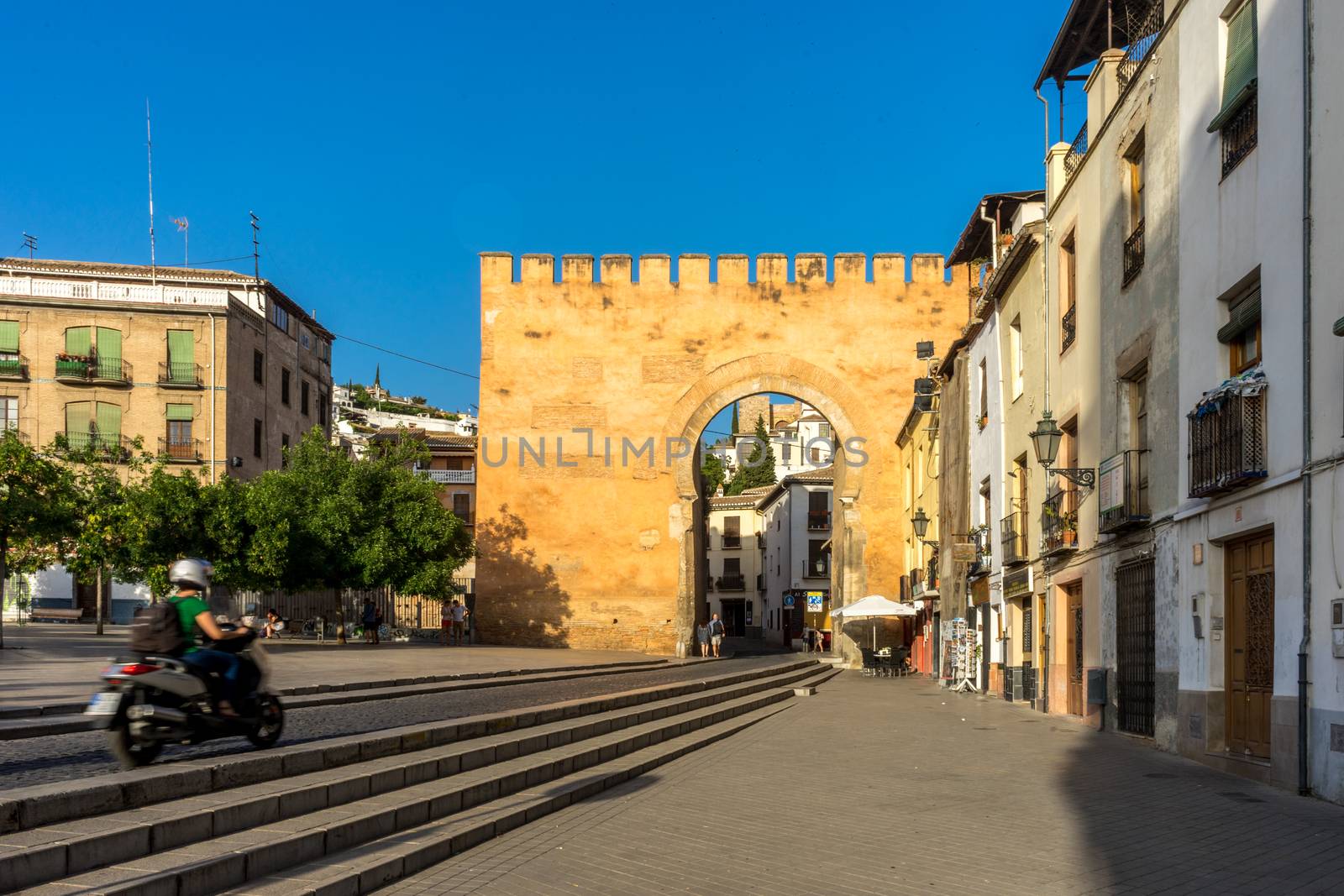 old Entrance wall to the city of Granada, Spain, Europe during golden hour of sunset on a bright sunny day